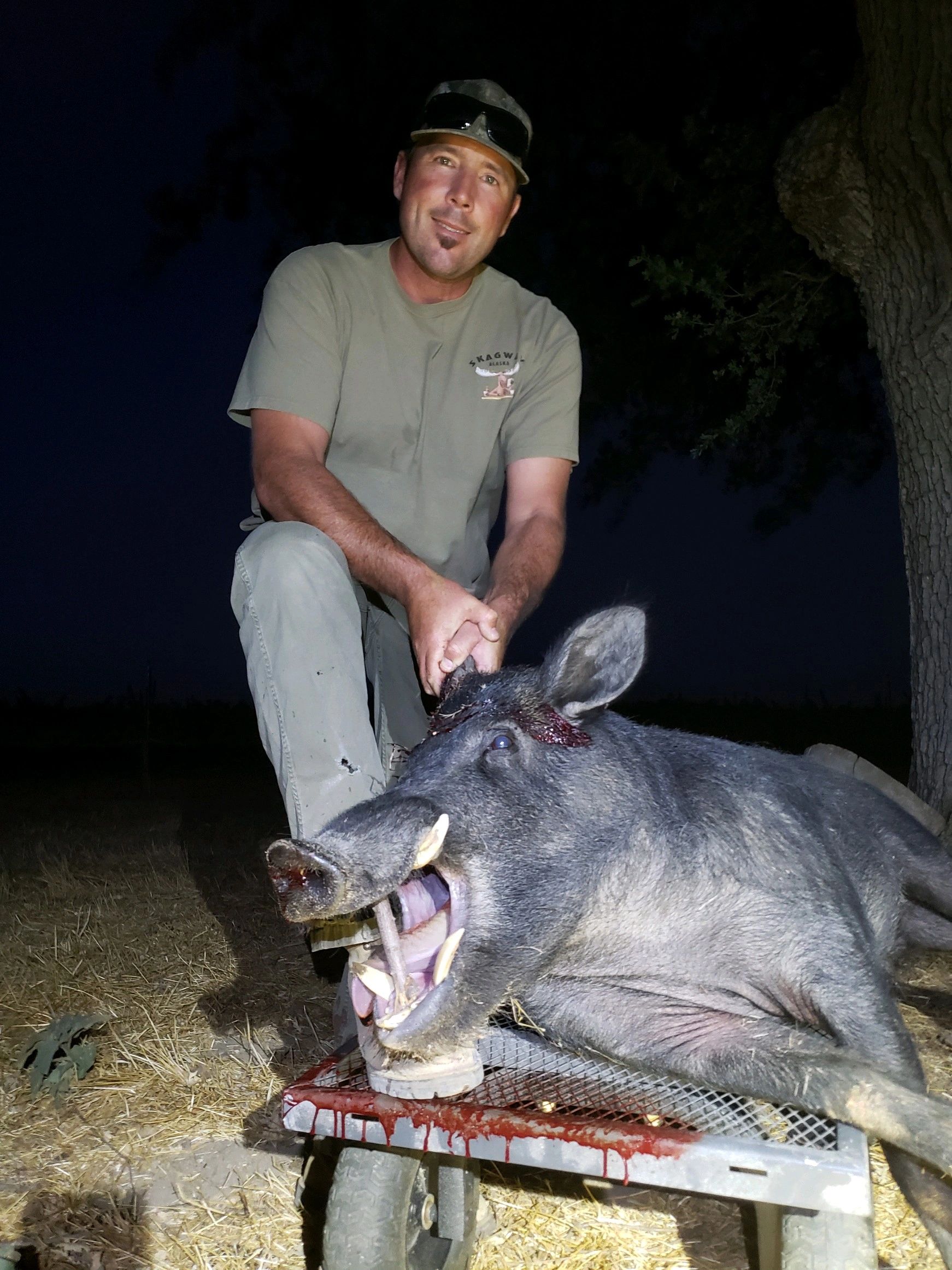 Hunter posing with trophy at night